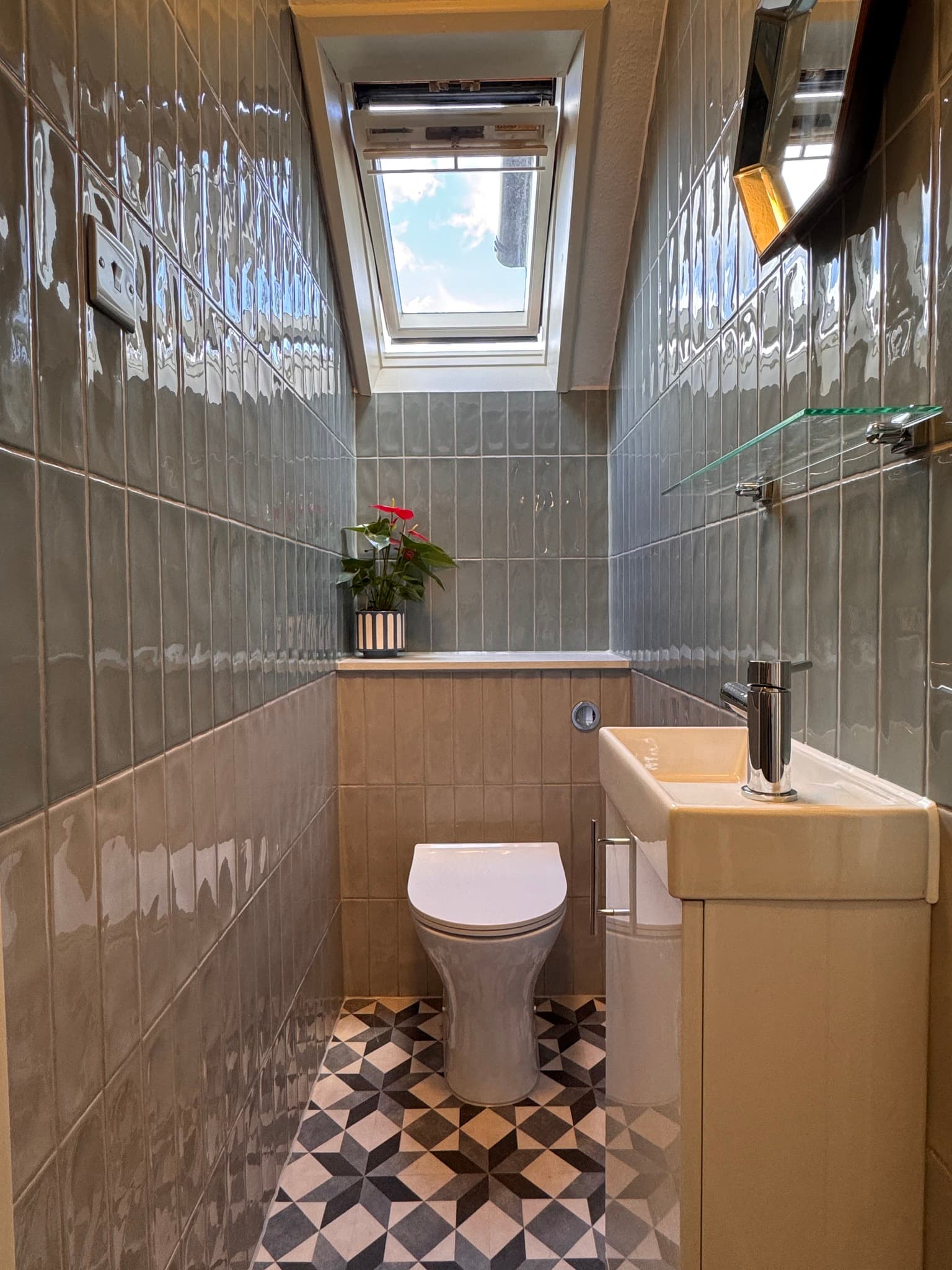 Cloakroom with grey gloss metro tiles and geometric floor