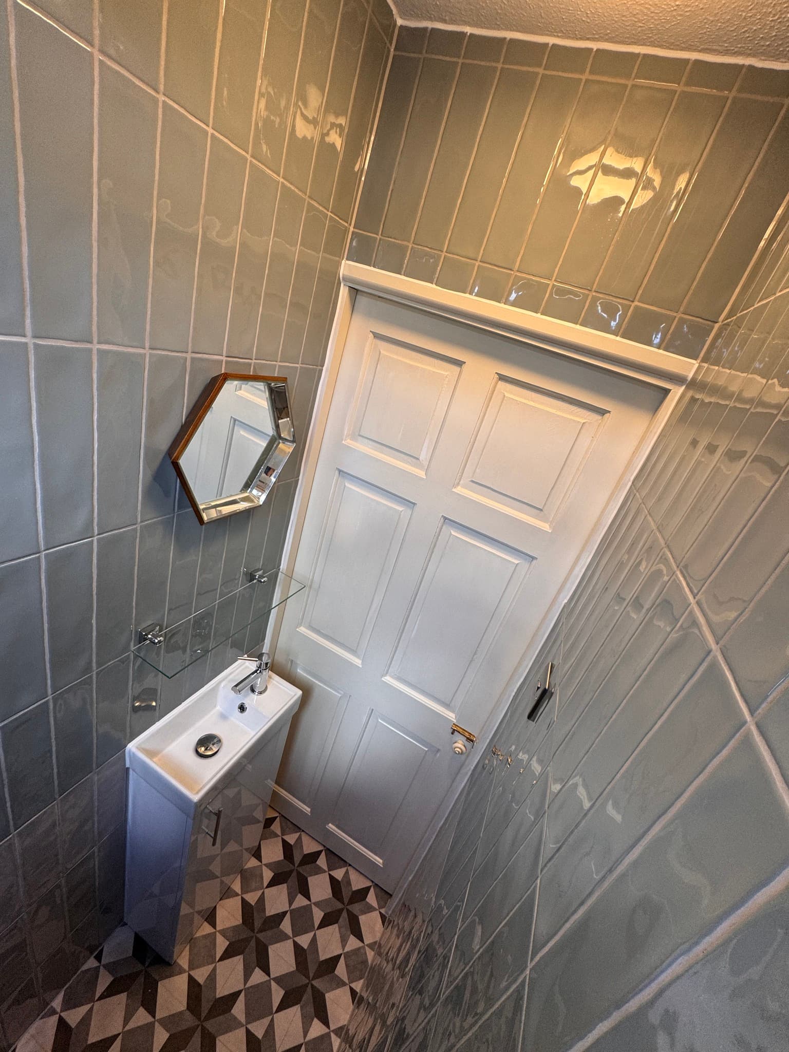 Cloakroom with gloss grey metro tiles