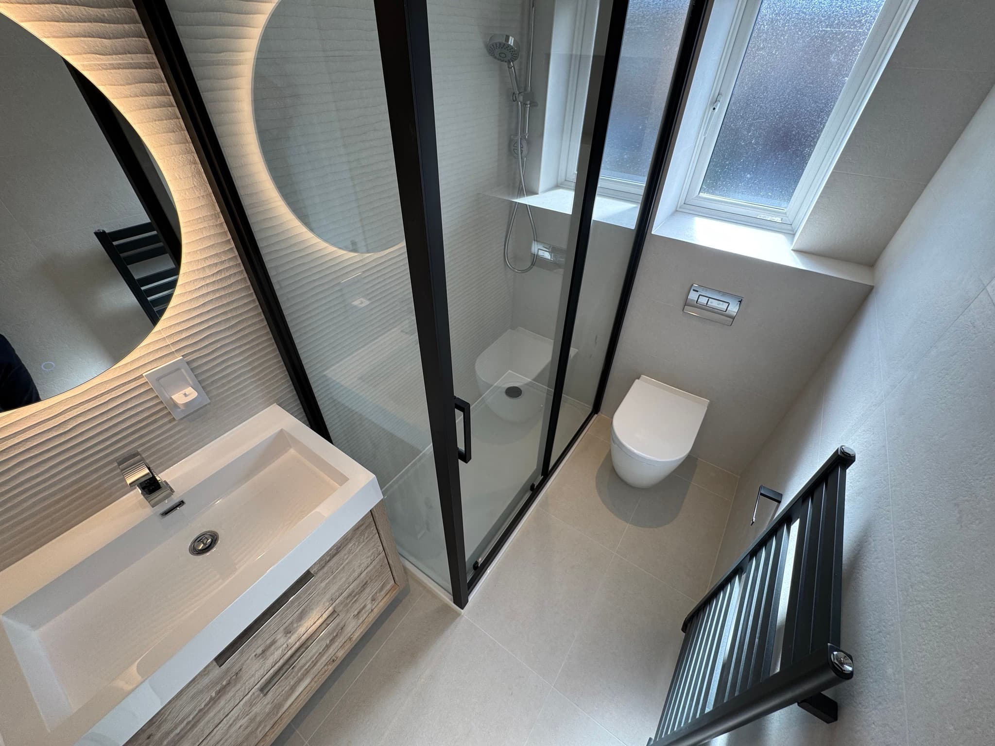 Contemporary en-suite overhead with wave-texture tiles