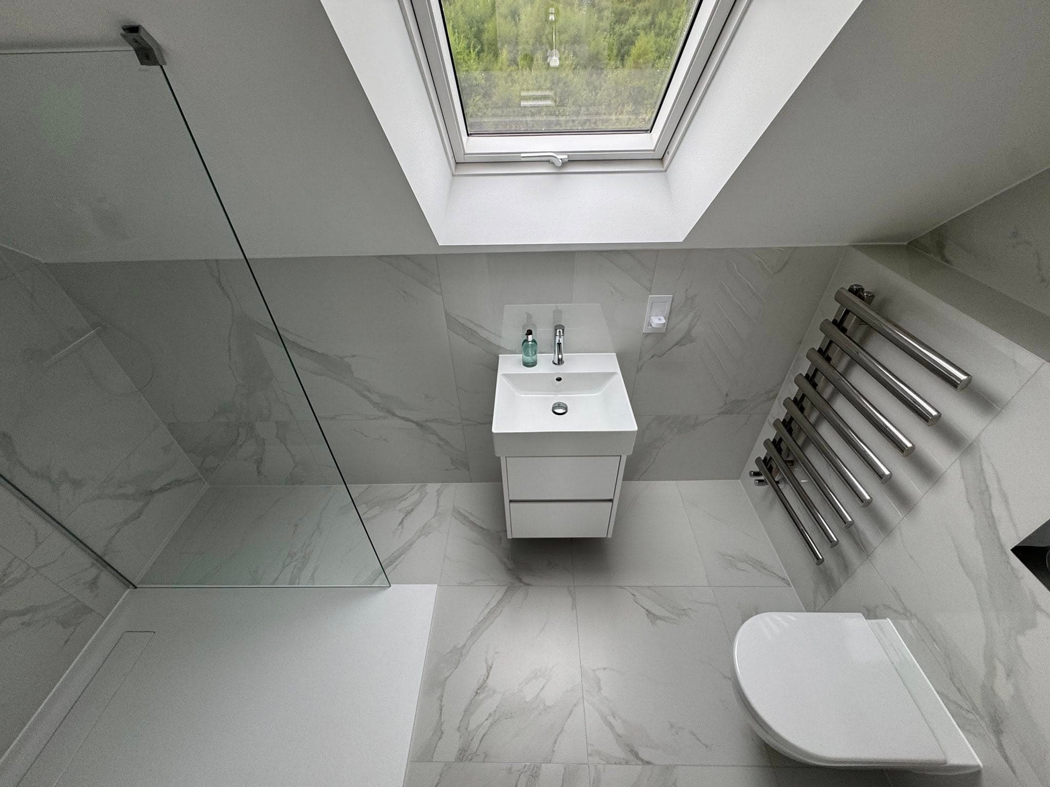 White marble-effect en-suite with walk-in shower and Velux skylight