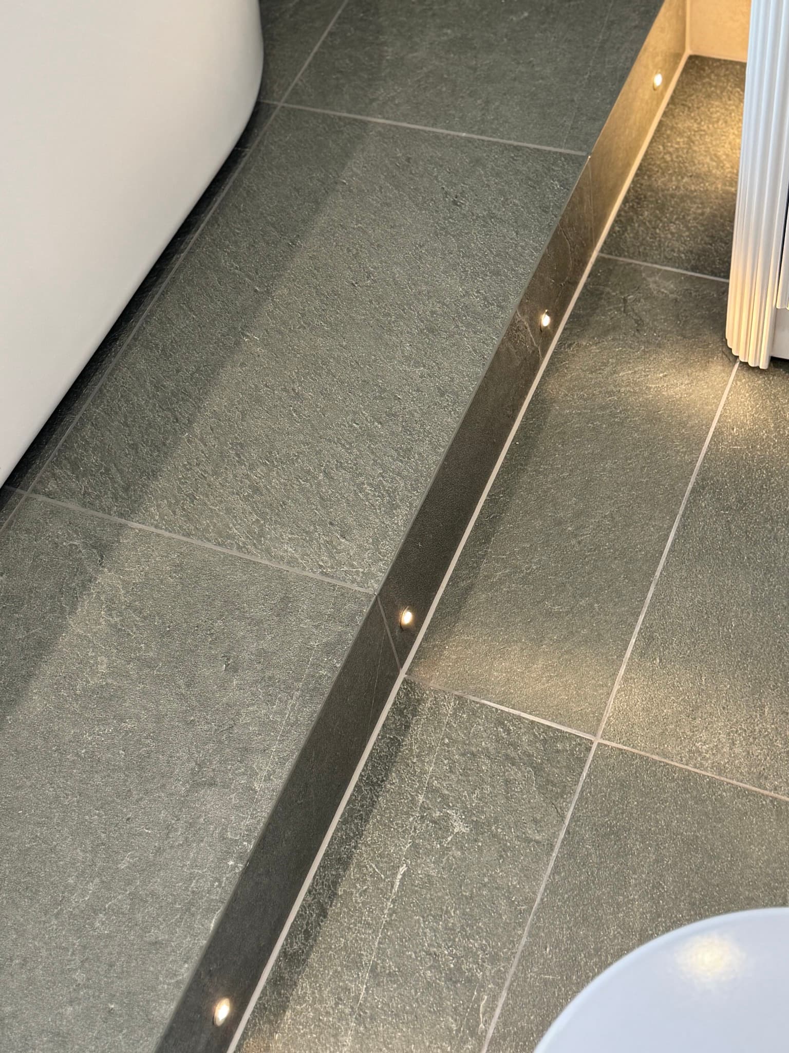 Finished bathroom tile detail with clean grout lines and polished edges